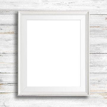 White picture frame on white wood wall.