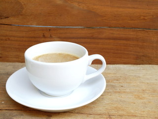 cup of coffee on a wooden table background