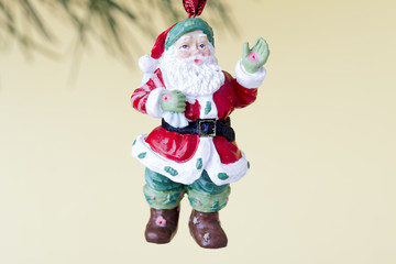 father santa hanging on christmas tree.