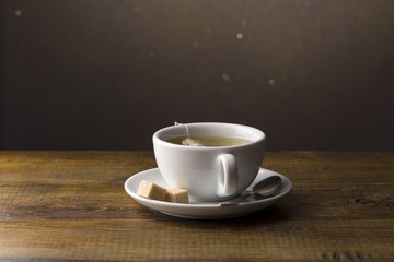 Tea cup with tea bag on saucer