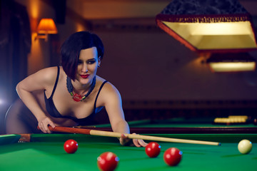 Hot sexy young woman at billiards club playing snooker - obrazy, fototapety, plakaty
