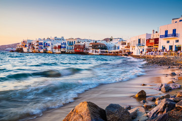 Rolling waves and sunset dining at fmaous Mykonos neighborhood of Little Venice, Mykonos, Greece