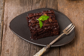 Cake chocolate brownies with dark chocolate  dressing and mint