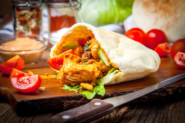 Fried chicken meat with vegetables in pita bread
