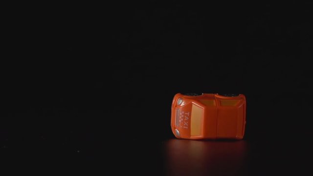 SLOW: A toy car drive and turns upside down 