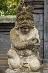 Fototapeta na wymiar Traditional guard statue carved in stone on Bali, Indonesia.