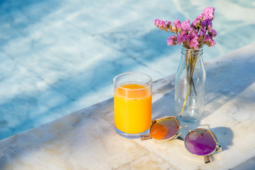relax time at the pool with orange juice