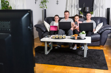 Fototapeta na wymiar Modern family in front of tv