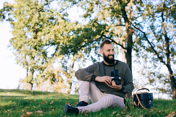 man photographer is making landscape photography with old film camera medium format