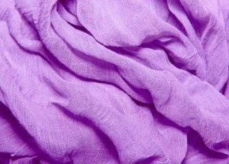 Fototapeta na wymiar fabric texture cotton and silk crumpled blue folds lying on a ta
