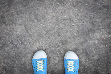 Blue shoes standing on concrete floor