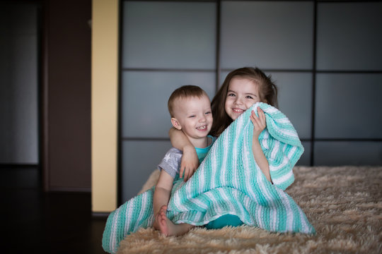 boy and girl hiding under the blanket