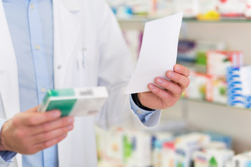 Pharmacist filling prescription in pharmacy - obrazy, fototapety, plakaty