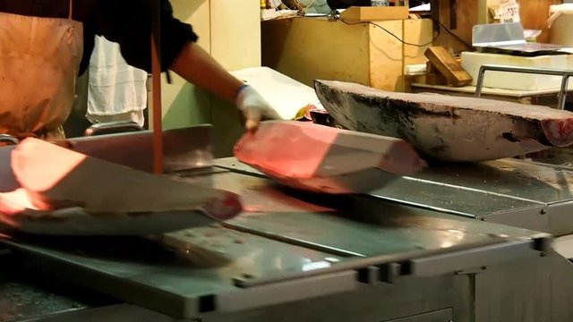 Cutting tuna by machine in the fish market