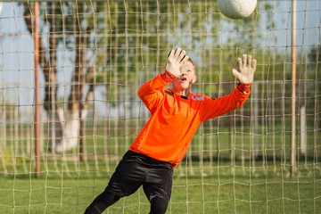 boy goalkeeper defends