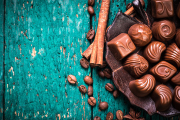 Delicious chocolate candies on wooden background