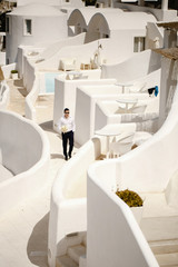 Happy groom with bouquet in the hotel outside