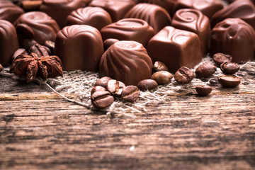 Delicious chocolate candies on wooden background