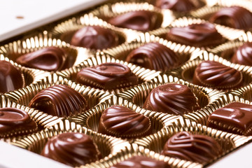 Delicious chocolate candies on wooden background