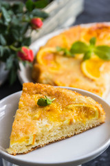 Orange cake, decorated with fresh mint (selective focus)