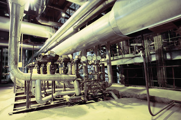 Equipment, cables and piping as found inside of a modern industr