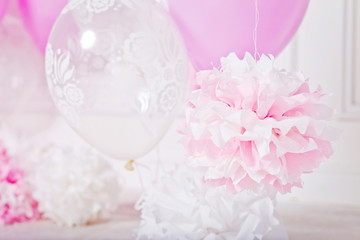 Pompoms and ballons for a party. Pink and white colors