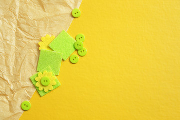 yellow background with crumpled paper, green buttons and squares