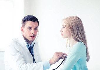 doctor with stethoscope listening to the patient