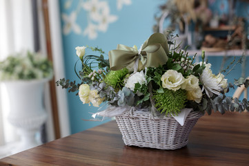 Beautiful flower in a basket with green ribbon