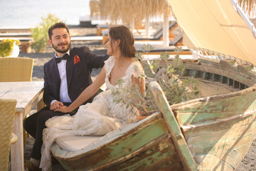 Fototapeta premium bride and groom relaxing on a wooden boat