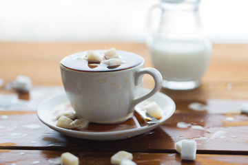 close up of sugar in coffee cup on wooden table