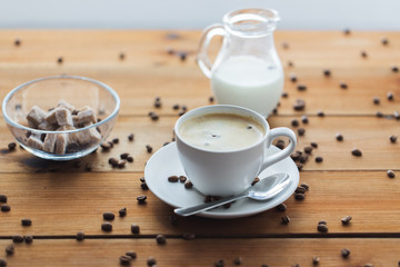 close up coffee cup and grains on wooden table