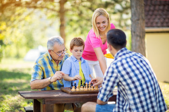 family relax time playing chess.