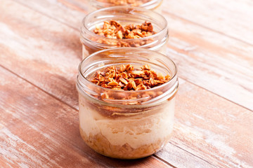 dessert with cream, granola and jam, closeup, horizontal