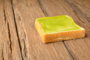 sliced thai custard bread on wood table