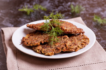 Delicious potato pancakes on plate with dill