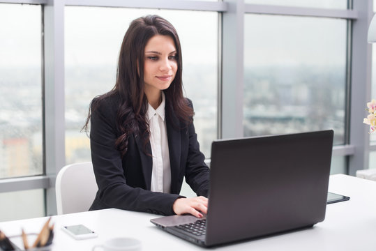 Young business woman with notebook in the office, workplace