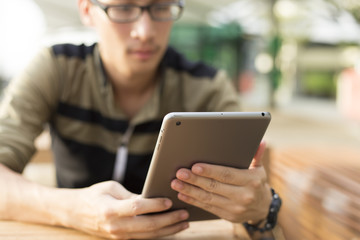 Man Typing a Tablet