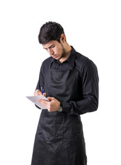 Young chef or waiter wearing black apron isolated