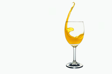 White wine splash into glass isolated on white background.