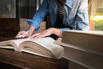 Woman sitting in a cafe, reading book
