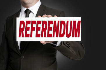 referendum placard is held by businessman