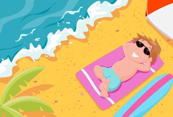 Obraz na płótnie Canvas boy lying on the beach wearing sunglasses
