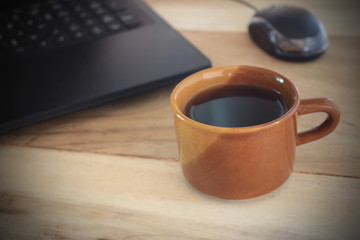 coffee cup and office desk with laptop computer