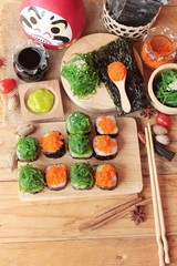 Fototapeta na wymiar Sushi roll with seaweed salad and shrimp eggs.