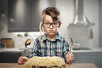 Surprised young boy in glasses with spaghetti © path21
