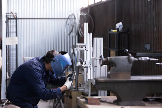 Unrecognizble man welding iron details