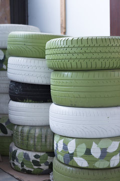 Green and white painted car tires