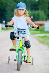 Fototapeta premium Little girl ride a bike