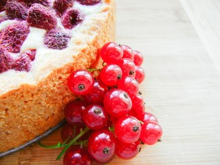 raspberry pie decorated with fresh red currants